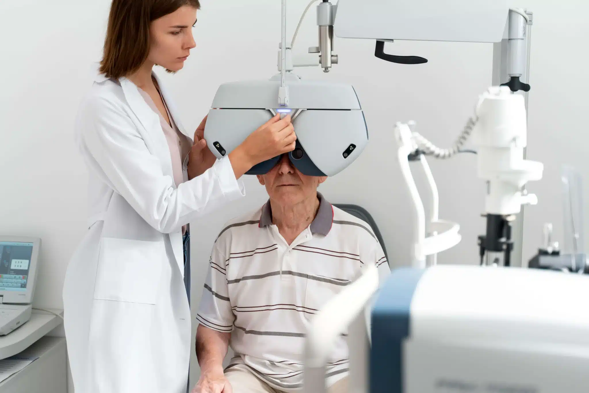 An elderly man gets an eye exam from his eye doctor. 